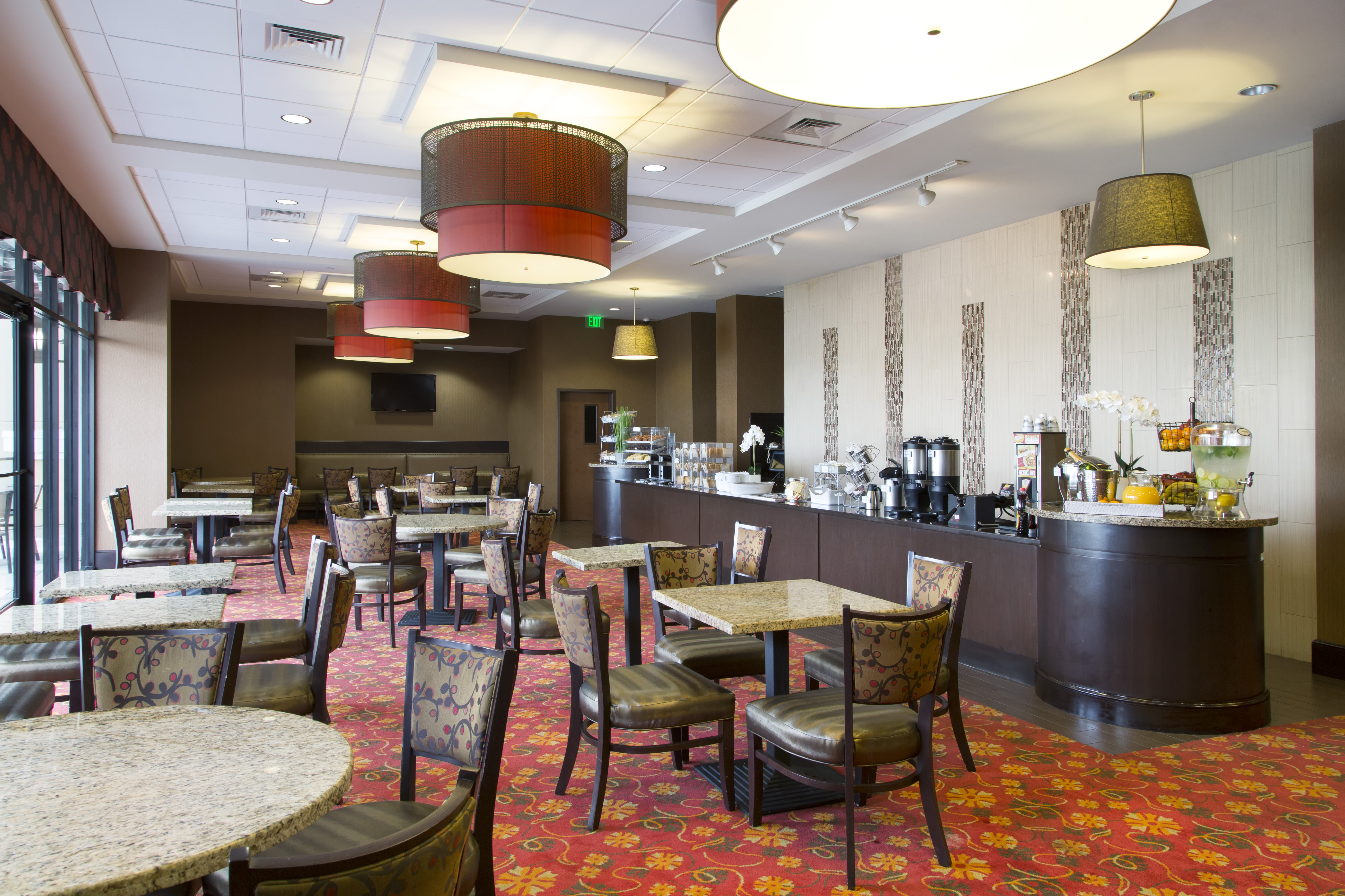 Ramada Plaza by Wyndham Orlando Resort & Suites Intl Drive restaurant breakfast area with seating in Orlando, Florida